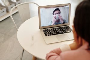 Looking over the shoulder of someone on a video call with another person
